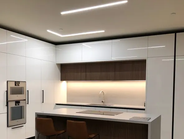 An indoor kitchen space with luminaires.